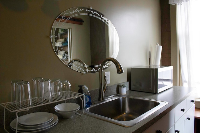 kitchen featuring white cabinets and sink