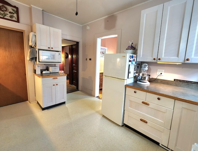 kitchen with white cabinetry and white appliances