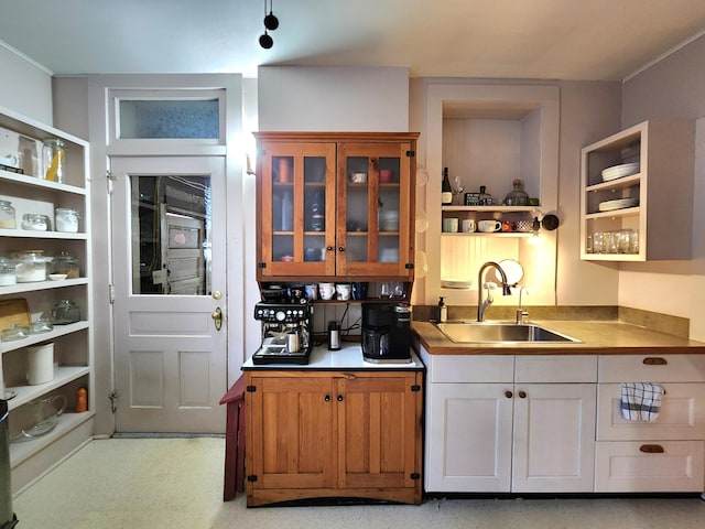 kitchen featuring white cabinets and sink