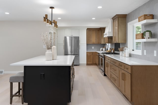 kitchen with pendant lighting, a center island, stainless steel appliances, and tasteful backsplash