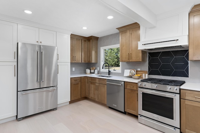 kitchen with white cabinets, decorative backsplash, sink, and appliances with stainless steel finishes