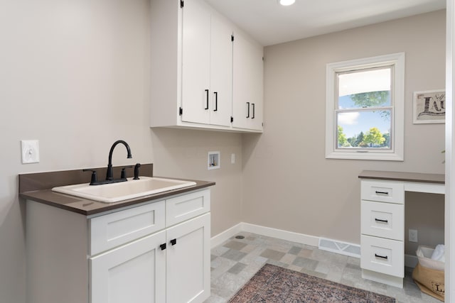 laundry area with washer hookup, cabinets, and sink