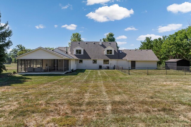 back of property featuring a sunroom and a yard