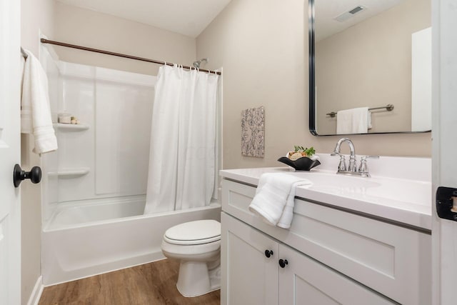 full bathroom featuring hardwood / wood-style floors, vanity, toilet, and shower / bath combo with shower curtain