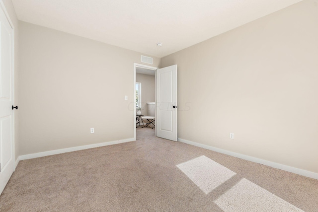 unfurnished bedroom featuring light carpet