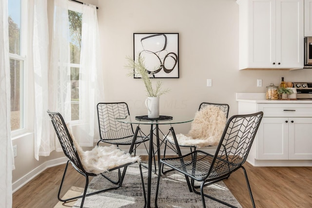 dining space with light wood-type flooring