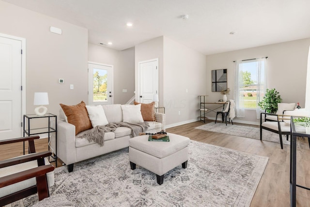 living room with a wealth of natural light and light wood-type flooring