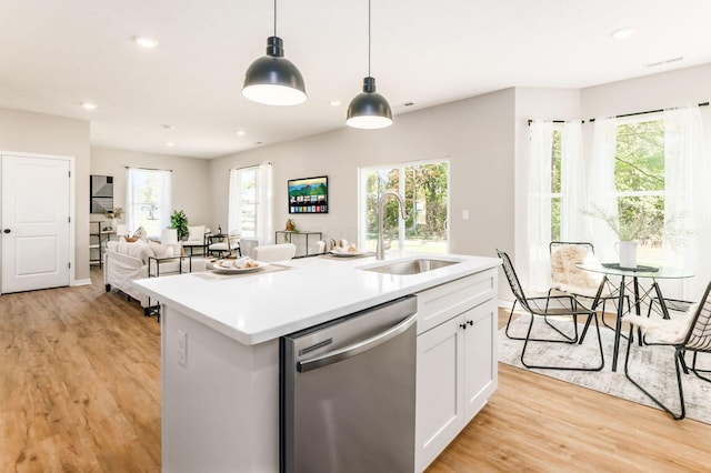 kitchen featuring dishwasher, white cabinetry, and a wealth of natural light