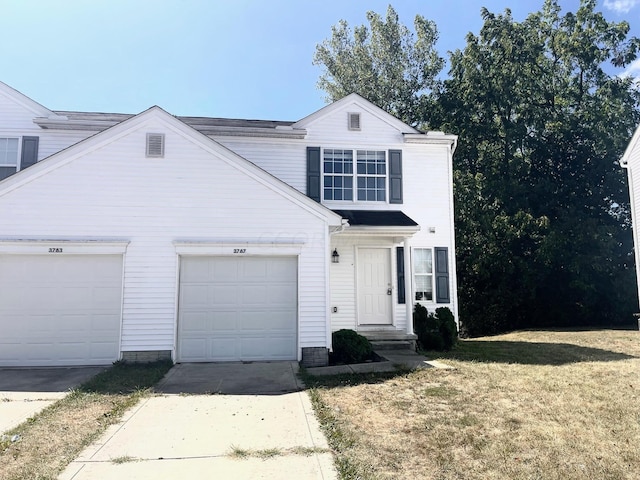 front facade with a front yard and a garage