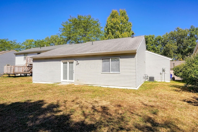 back of property featuring a yard, central AC, and a wooden deck