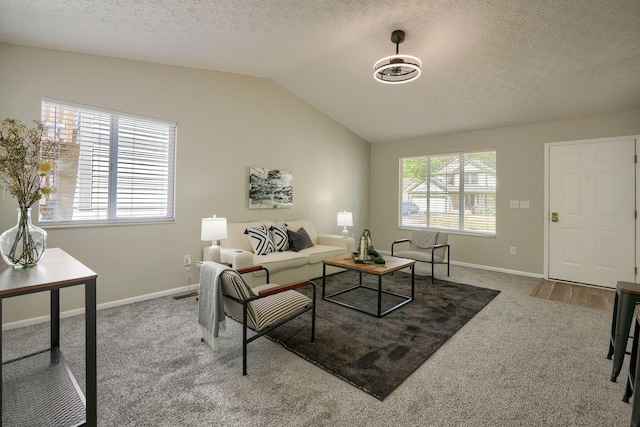 living room featuring carpet flooring, a textured ceiling, and vaulted ceiling