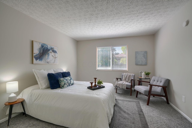 bedroom featuring carpet floors and a textured ceiling