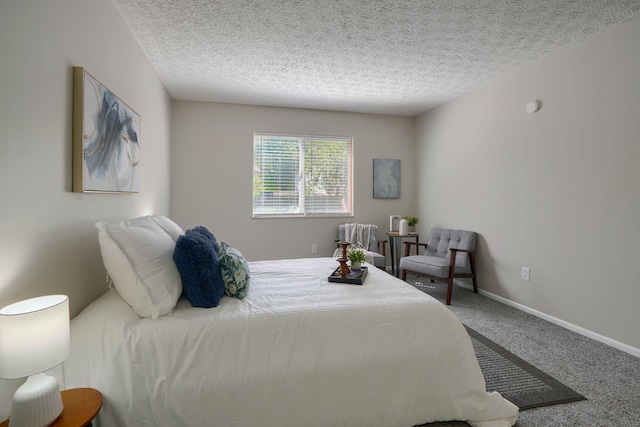 bedroom with carpet floors and a textured ceiling