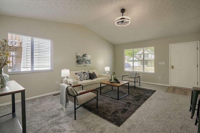 living room featuring carpet flooring, a textured ceiling, and vaulted ceiling