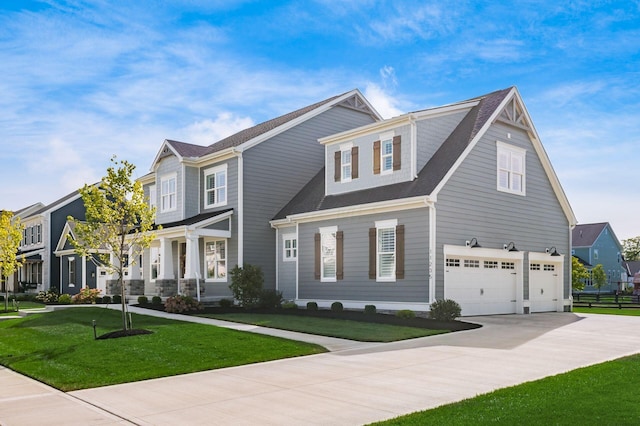 view of front of house featuring a garage and a front lawn