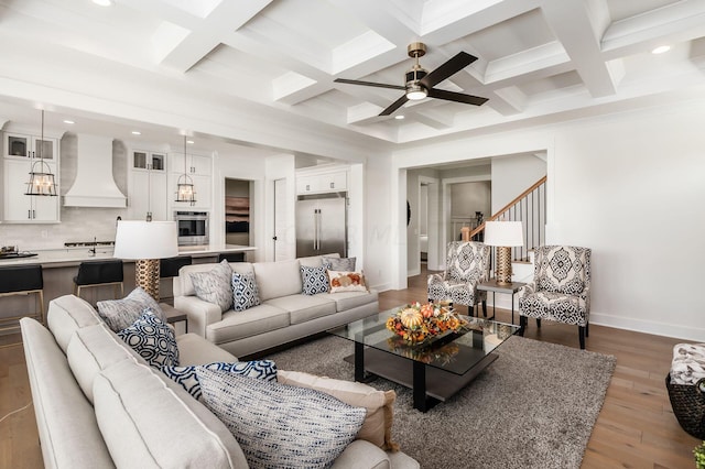 living room featuring beamed ceiling, ceiling fan, coffered ceiling, and dark hardwood / wood-style floors