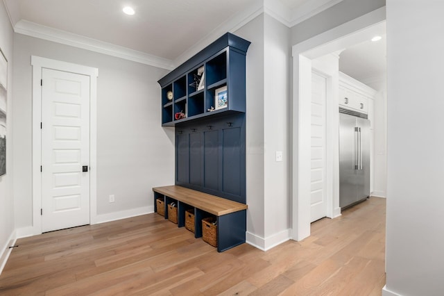 mudroom with ornamental molding and light wood-type flooring