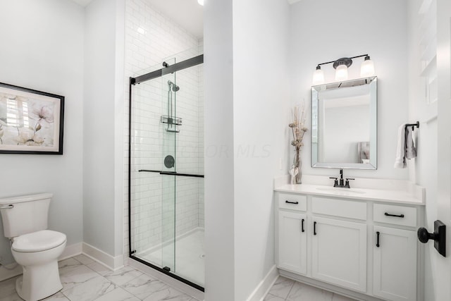 bathroom with vanity, a shower with shower door, and toilet