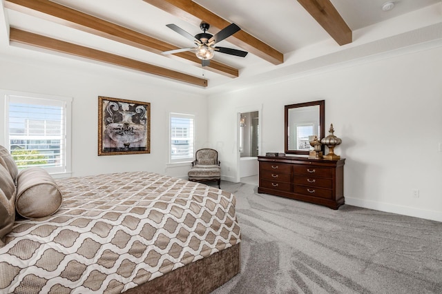 bedroom featuring beamed ceiling, light colored carpet, and ceiling fan