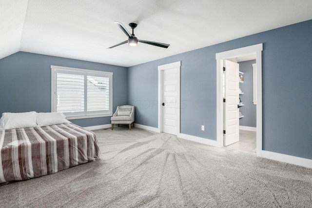 unfurnished bedroom with vaulted ceiling, light colored carpet, and ceiling fan