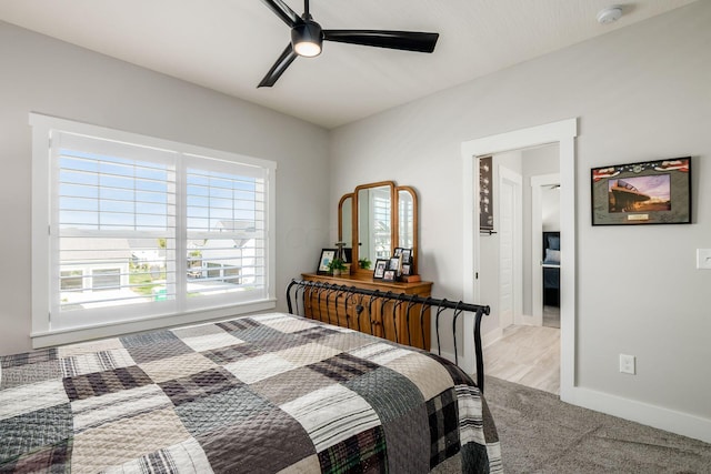 bedroom featuring light colored carpet and ceiling fan