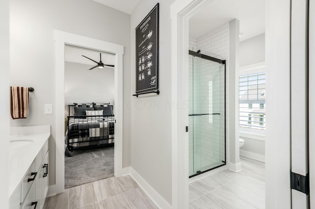 bathroom with vanity, an enclosed shower, ceiling fan, and toilet