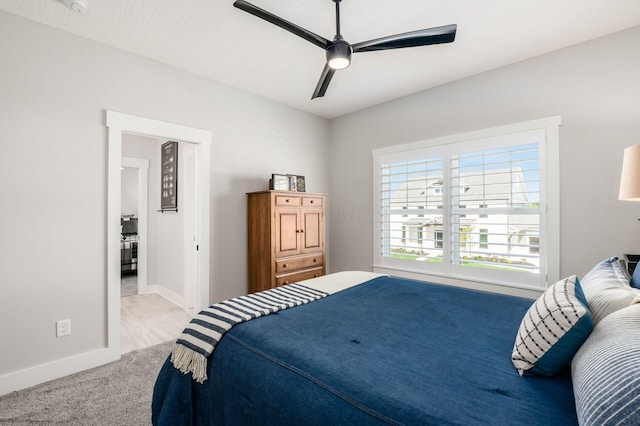 bedroom featuring light carpet and ceiling fan