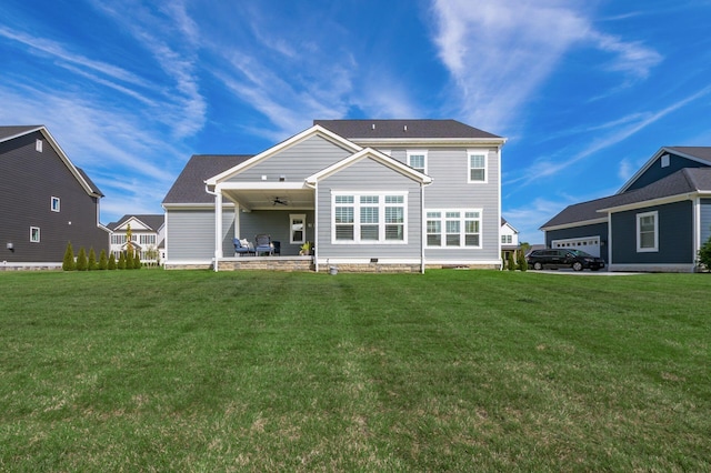 rear view of property featuring a yard and covered porch