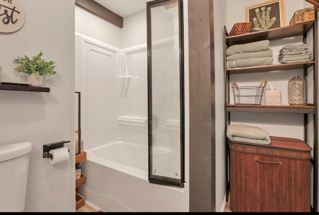 bathroom with bathtub / shower combination and toilet