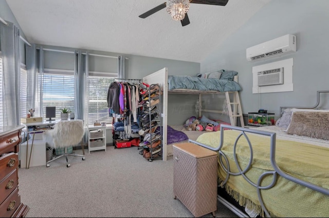 carpeted bedroom featuring a wall unit AC, lofted ceiling, ceiling fan, an AC wall unit, and a textured ceiling