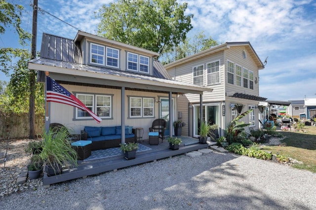 view of front of property featuring metal roof and an outdoor living space