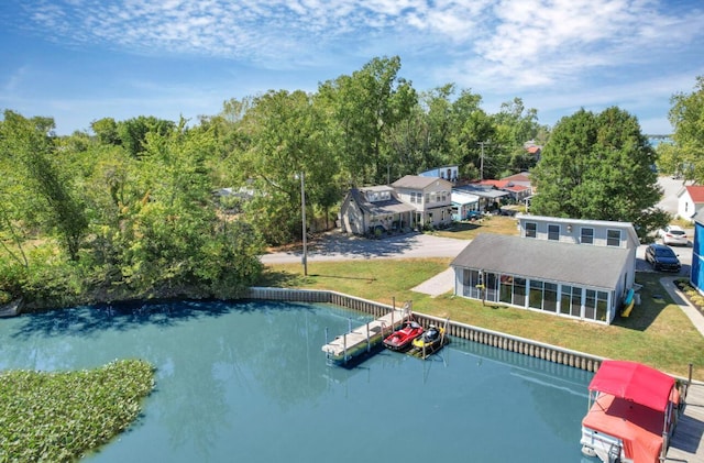 view of swimming pool with a sunroom, a boat dock, and a lawn