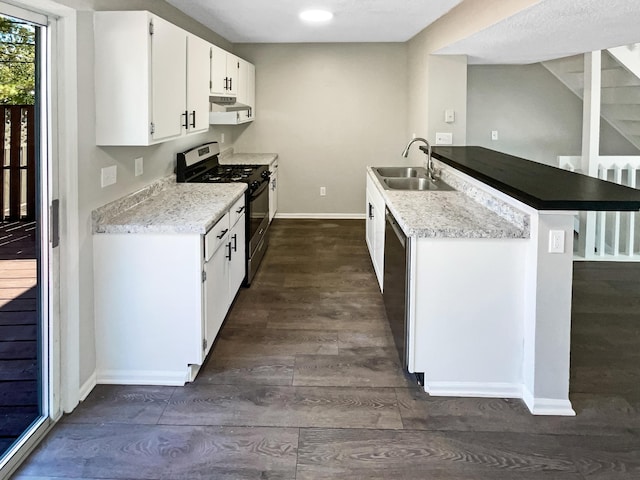 kitchen featuring kitchen peninsula, appliances with stainless steel finishes, sink, dark hardwood / wood-style floors, and white cabinetry