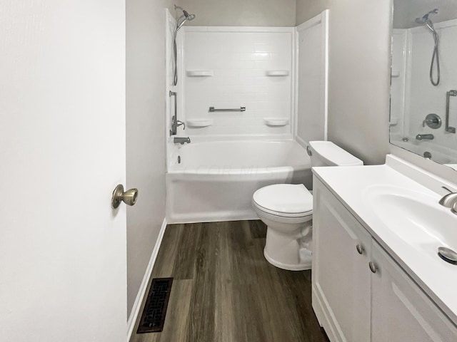 full bathroom featuring vanity, hardwood / wood-style flooring, toilet, and shower / washtub combination