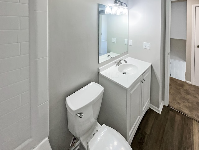 bathroom with hardwood / wood-style flooring, vanity, and toilet