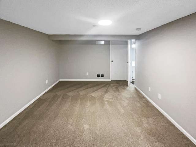 basement featuring carpet and a textured ceiling