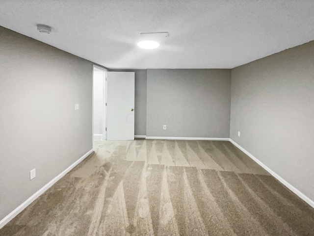 unfurnished room with carpet floors and a textured ceiling