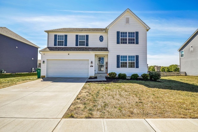 view of property featuring a front yard and a garage