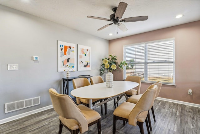 dining space with dark hardwood / wood-style floors, ceiling fan, and a textured ceiling