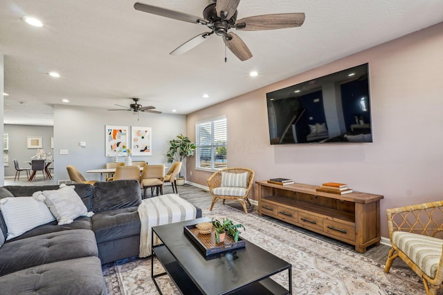 living room with light wood-type flooring and ceiling fan