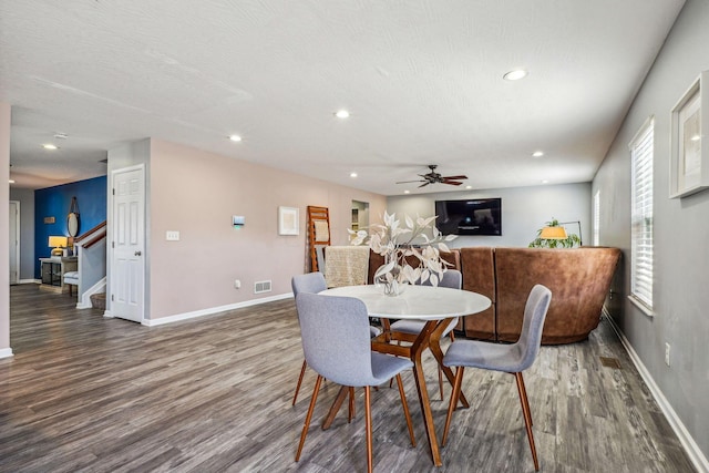 dining area featuring a textured ceiling, dark hardwood / wood-style flooring, and ceiling fan