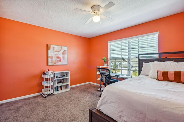 carpeted bedroom featuring ceiling fan and a textured ceiling