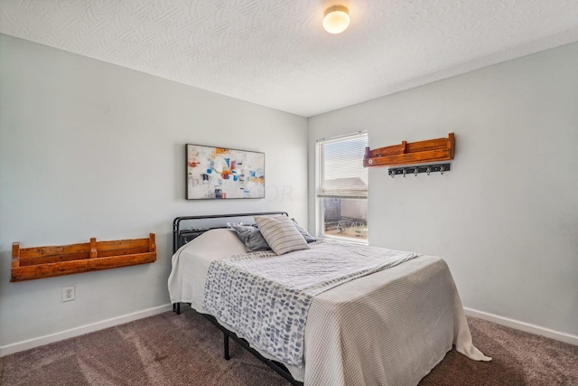 bedroom with carpet and a textured ceiling