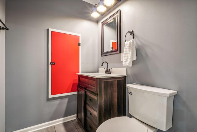 bathroom with tile patterned floors, vanity, and toilet