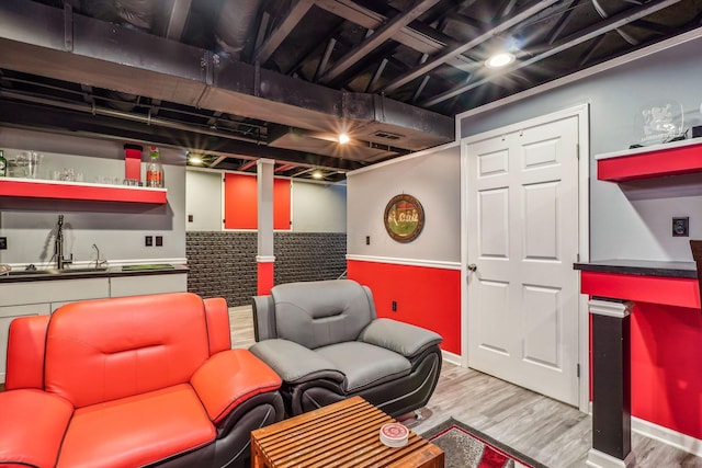 recreation room with hardwood / wood-style floors and sink