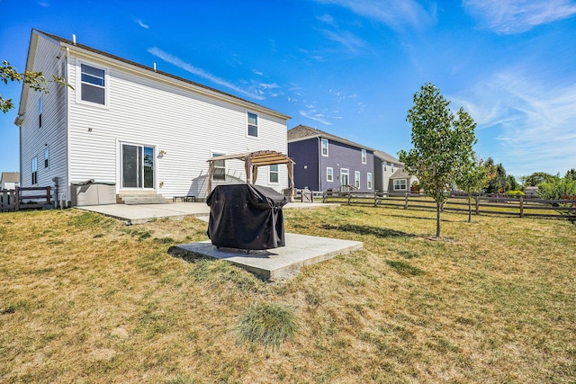 back of property featuring a lawn, a pergola, and a patio