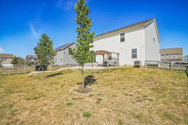 back of property featuring a pergola, a yard, cooling unit, and a patio