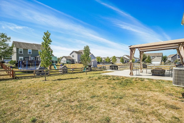 view of yard with a playground, a patio area, cooling unit, and a trampoline