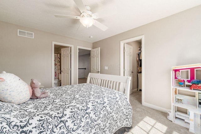 carpeted bedroom with connected bathroom, ceiling fan, and a closet