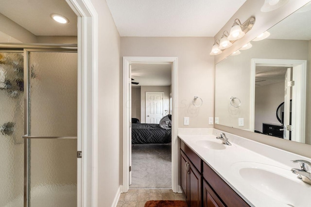 bathroom featuring ceiling fan, walk in shower, and vanity